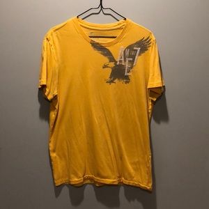 Men’s yellow tee, with graphic logo